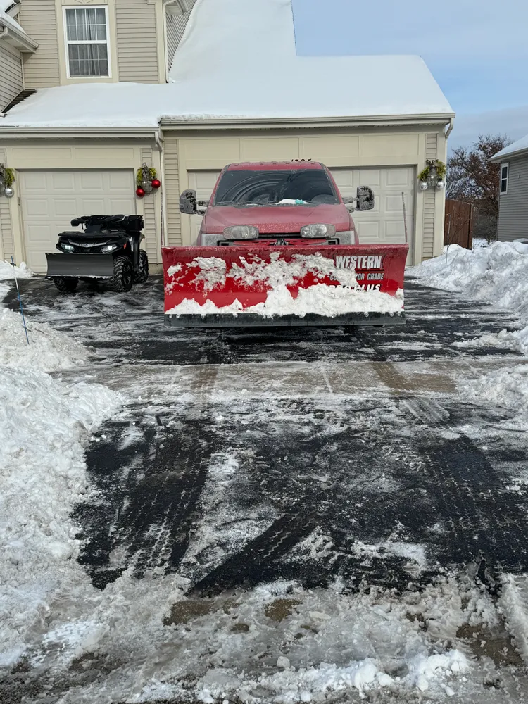 Premier snow plow clearing residential driveway
